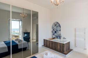 a bedroom with a bed and a mirror at Relais Mareluna - Luxury Apartments in Salerno
