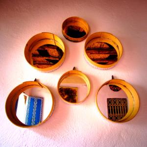 a group of four mirrors on a wall at Ayouze Auberge in Aït Benhaddou