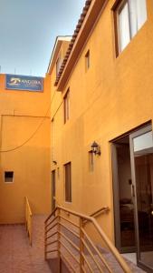 a building with a sign on the side of it at Casa Huespedes Angoba in Arica