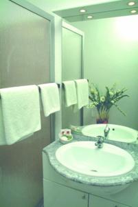 
a bathroom sink with a towel hanging on the wall at Dillinger Hof in Dillingen an der Donau
