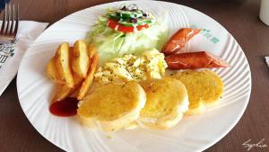 a white plate of food with pancakes and french fries at Taitung Venice B&B in Taitung City