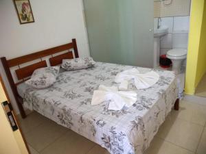 Uma cama ou camas num quarto em Pousada Aritibe