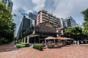 a large building with tables and chairs in front of it at M Social Singapore (SG Clean, Staycation Approved) in Singapore