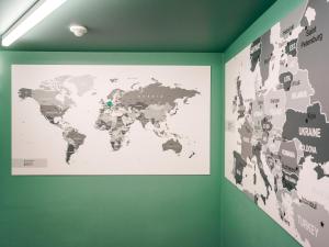 a map of the world on a green wall at BRATWURSThotel in Georgensgmünd