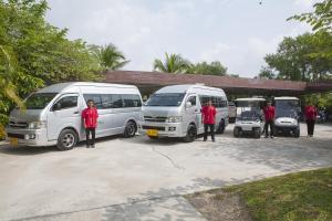 a group of three vans parked in a parking lot at Railay Village Resort in Railay Beach