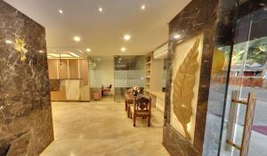 a living room with a table and a stone wall at Calangute Grande in Calangute