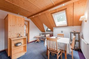a kitchen and dining room with a table and chairs at Alpin Apart Maurer in Längenfeld