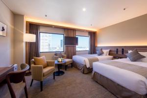 Postel nebo postele na pokoji v ubytování Kawasaki Nikko Hotel