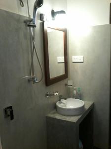 a bathroom with a sink and a mirror at Secret Palace Guest house in Galle