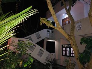 a building with a tree in front of it at Seagull's Nest in Tangalle