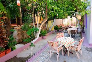 a patio with a table and chairs and trees at Ozmen Hotel Old Town Kaleiçi in Antalya