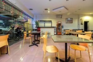 a dining room with tables and chairs in a restaurant at RedDoorz near Bethesda Manado in Manado