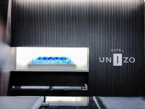 a black wall with a piano in a room at HOTEL UNIZO Hakataeki Hakataguchi in Fukuoka