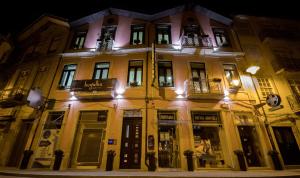a large yellow building with windows at night at Bugalha My Loft Douro 8 in Peso da Régua