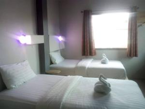 Ein Bett oder Betten in einem Zimmer der Unterkunft Thapae Gate Lodge