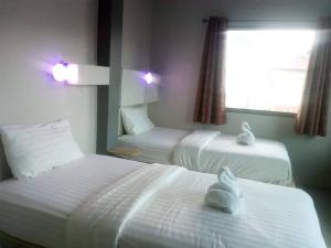 Ein Bett oder Betten in einem Zimmer der Unterkunft Thapae Gate Lodge