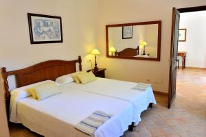 A bed or beds in a room at Petit Hotel Es Figueral