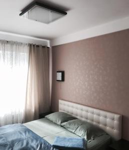 a bedroom with a bed and a window at Квартира in Kyiv