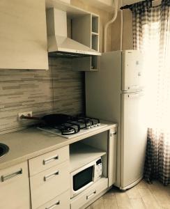 a kitchen with a white refrigerator and a stove top oven at Квартира in Kyiv