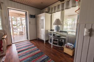 a kitchen with a desk and a table with a rug at Villa Helga - Beachfront in Hitis