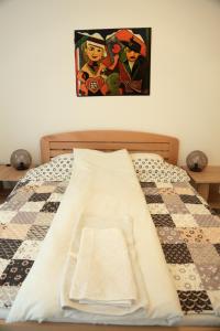 a bed with a quilt on it with at Petars Apartment in Belgrade