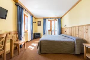 Postel nebo postele na pokoji v ubytování Hotel Crampon
