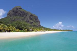 a sandy beach with a view of the ocean at Dinarobin Beachcomber Golf Resort & Spa in Le Morne