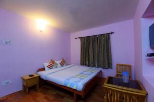 a small bedroom with a bed and a window at Abode Home Cool & Homely Place in Manāli