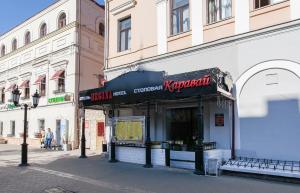 a store with a sign on the side of a street at Regina na Baumana in Kazan