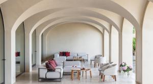 a living room with a white couch and chairs at Euphoria Retreat - A Holistic Wellbeing Destination Spa in Mystras