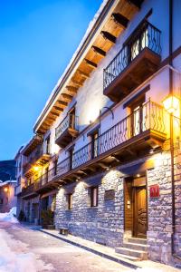 a building with balconies on the side of it at Apartamentos Casa Ríos in Biescas