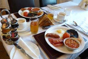 a breakfast table with two plates of eggs sausage beans and toast at The Thornhill in Teignmouth