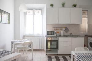 a kitchen with white cabinets and a stove top oven at Residenza Cleopatra 1 in Ancona