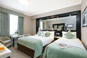 Cama ou camas em um quarto em Ashling Hotel Dublin