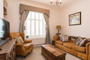 a living room with two couches and a tv at 145 New Road in Porthcawl