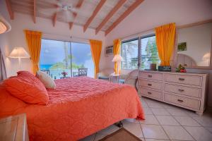 a bedroom with a bed and a view of the ocean at Stella Maris Resort Club in Stella Maris +24 photos