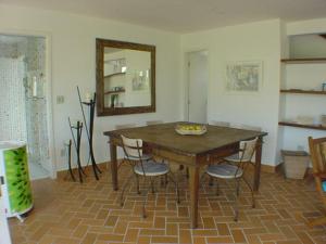 a dining room with a table and chairs and a mirror at Casa em condomínio fechado de frente para o mar e ao lado do rio in Praia Guaratuba +19 photos