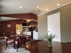 a dining room with tables and chairs and a white door at Oxford Inn and Suites Nasa in Webster