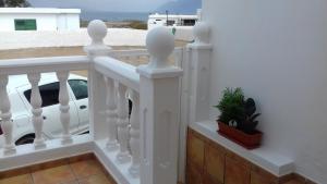 a white railing with a white car on a balcony at Casa Frasca in Teguise