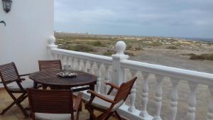 a table and chairs on a balcony with a view at Casa Frasca in Teguise