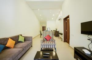 a living room with a couch and a table at Eternal wave by HappyInch in Calangute