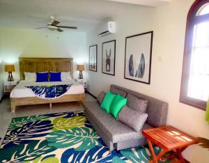 a living room with a couch and a bed at The Laughing Seahorse in Hato