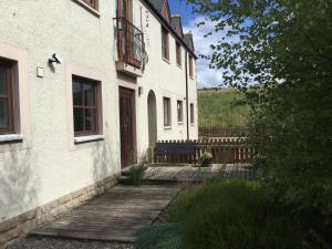 インバネスにあるTwo-Bedroom Apartment - Golf View Free Parkingの木造通路付きの家