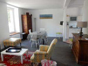 Appartement a dinard في دينارد: غرفة معيشة مع طاولة وكراسي