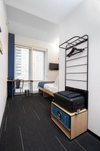 a bedroom with a bed and a desk at Pod Times Square in New York