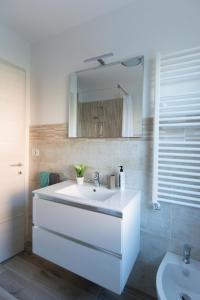 a bathroom with a white sink and a mirror at B&B Borgo Antico in Treviso