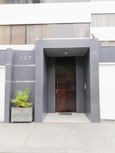 un edificio con una puerta y una maceta en Departamento Monterrico en Lima