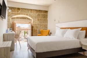 a bedroom with a large bed and a table and chairs at Salamanca Luxury Plaza in Salamanca