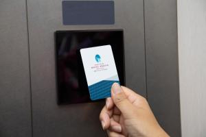 a person holding a cell phone in an elevator at Shizutetsu Hotel Prezio Hakataekimae in Fukuoka +62 photos