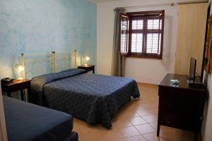 a hotel room with two beds and a window at Abbadia in San Vito lo Capo +38 photos